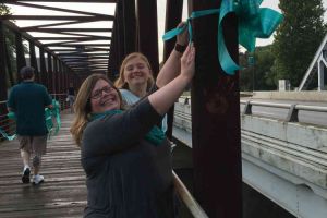 Blissfield Michigan Women Tying Ribbon On Bridge Support