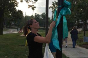 Blissfield Michigan Woman Tying Ribbon On Post
