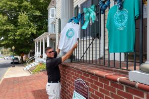 Milton DE Man Showing Teal Shirt